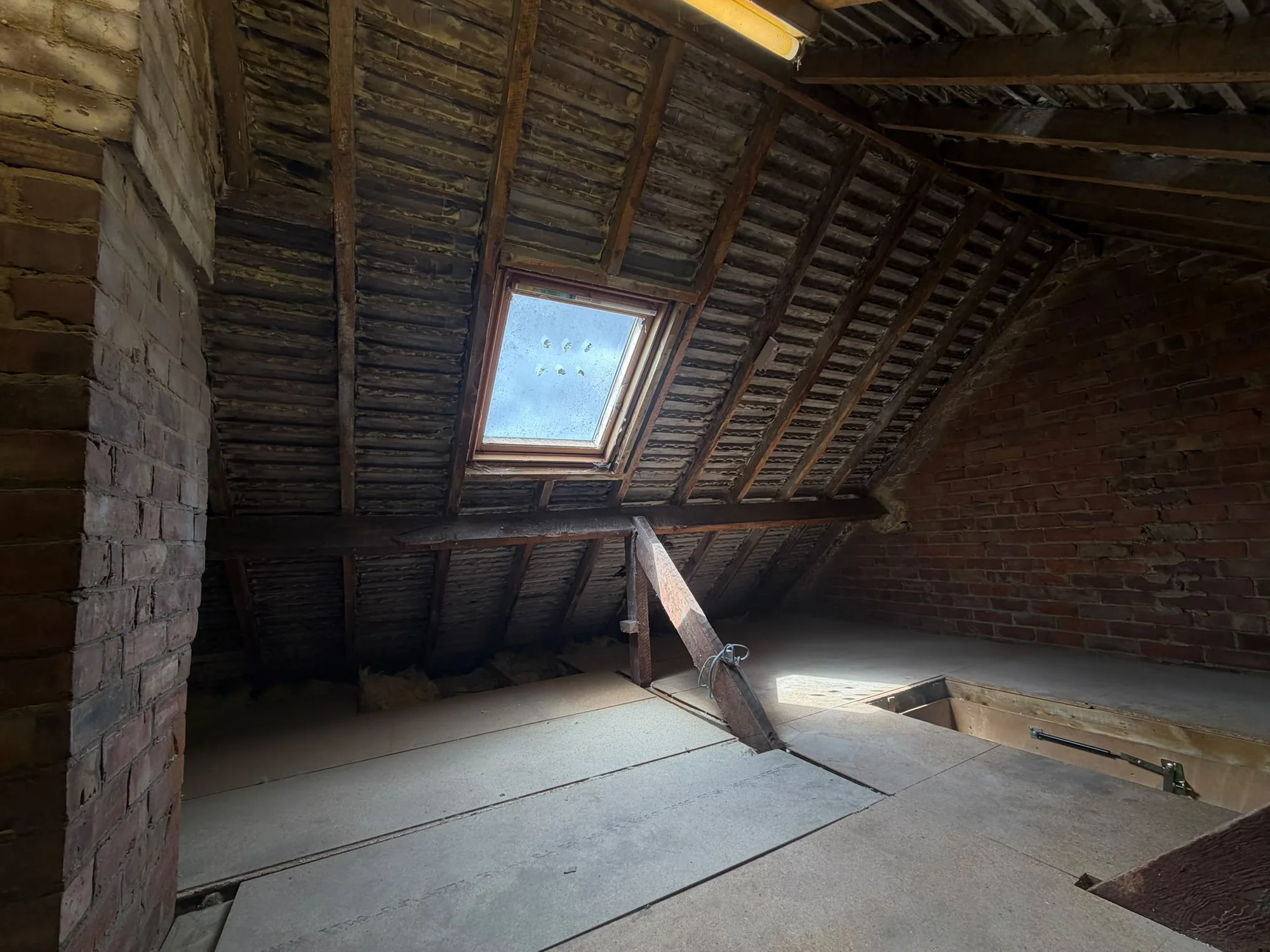 Cleared loft with a roof window